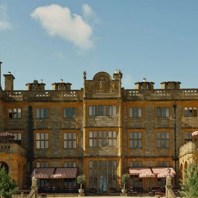 Stone facade and striped awnings at Estelle Manor in Oxfordshire