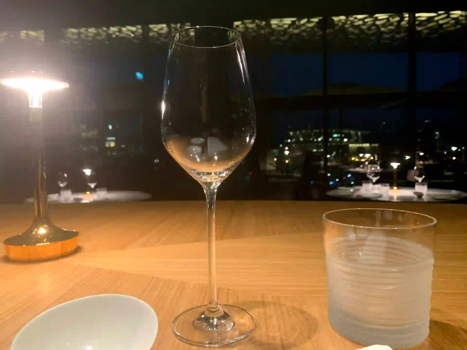 Wine glass on a candlelit dinner table at night